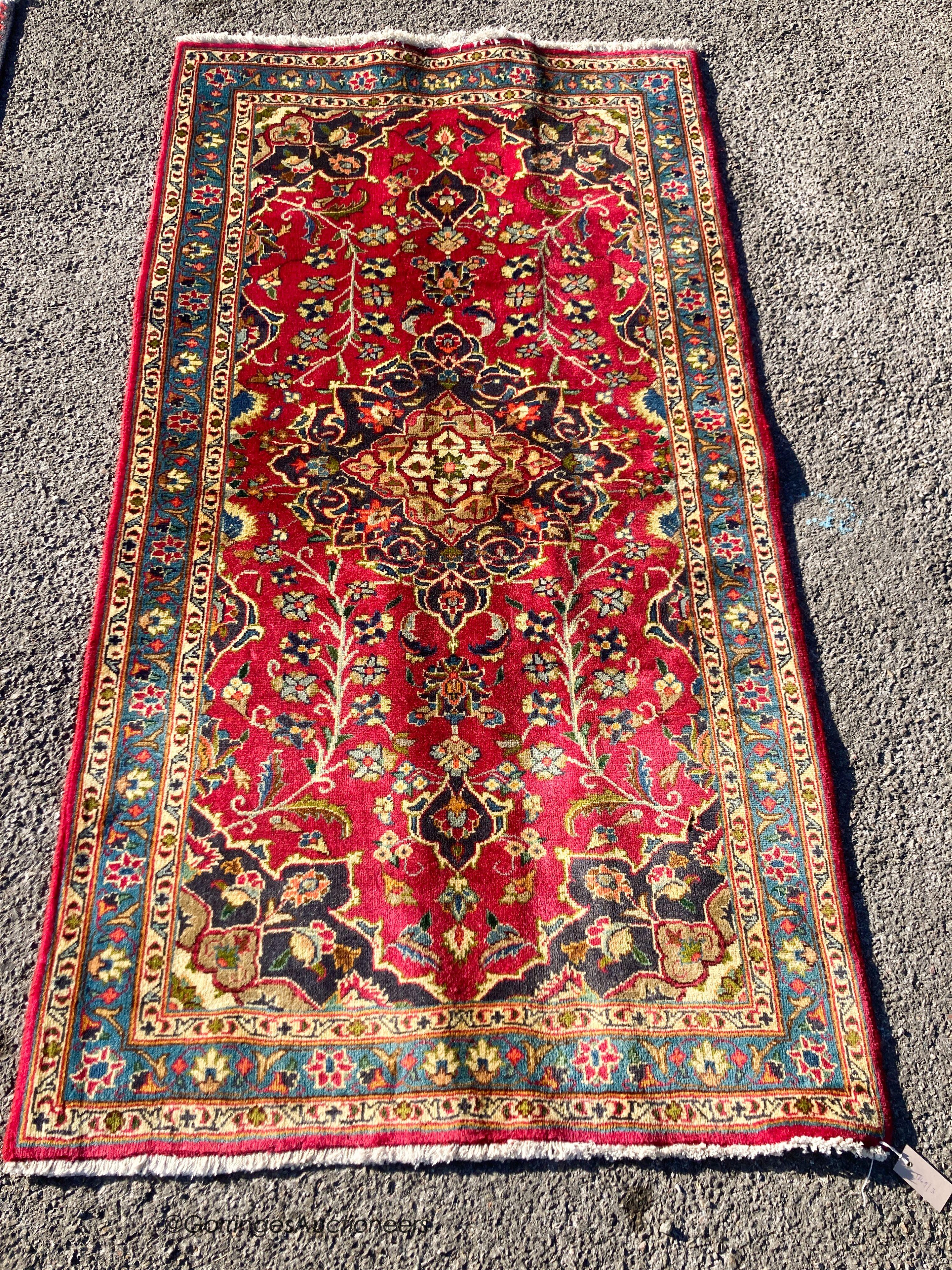 A Kashan claret ground rug, 186 x 93cm